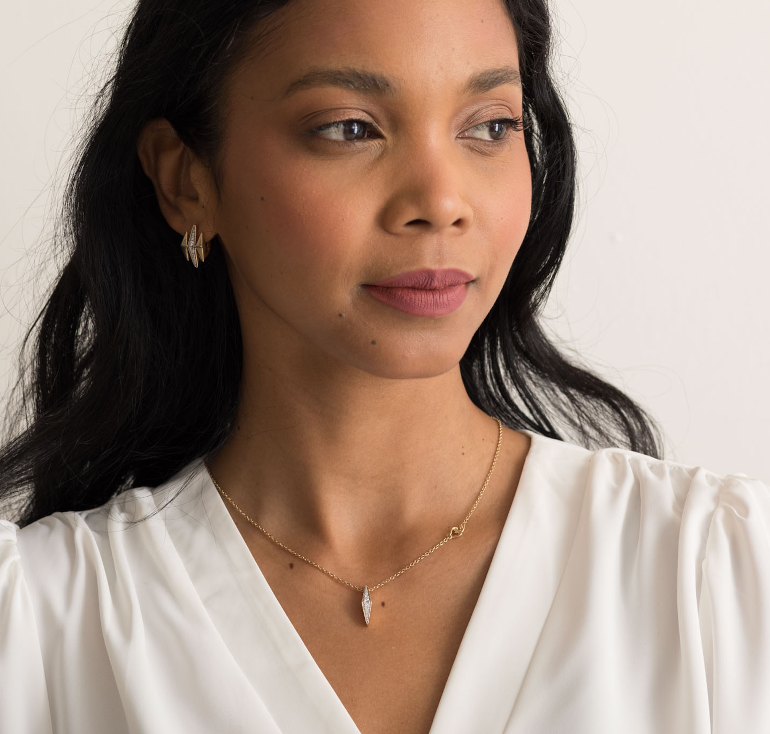 Woman wearing 14K solid gold diamond necklace with a delicate chain and pendant.