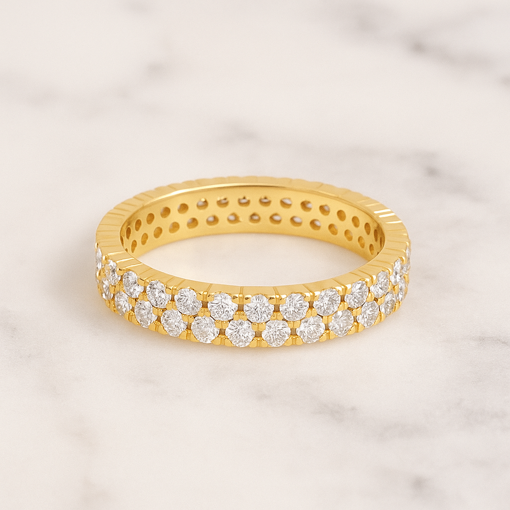 Gold ring with diamond stones on a marble background