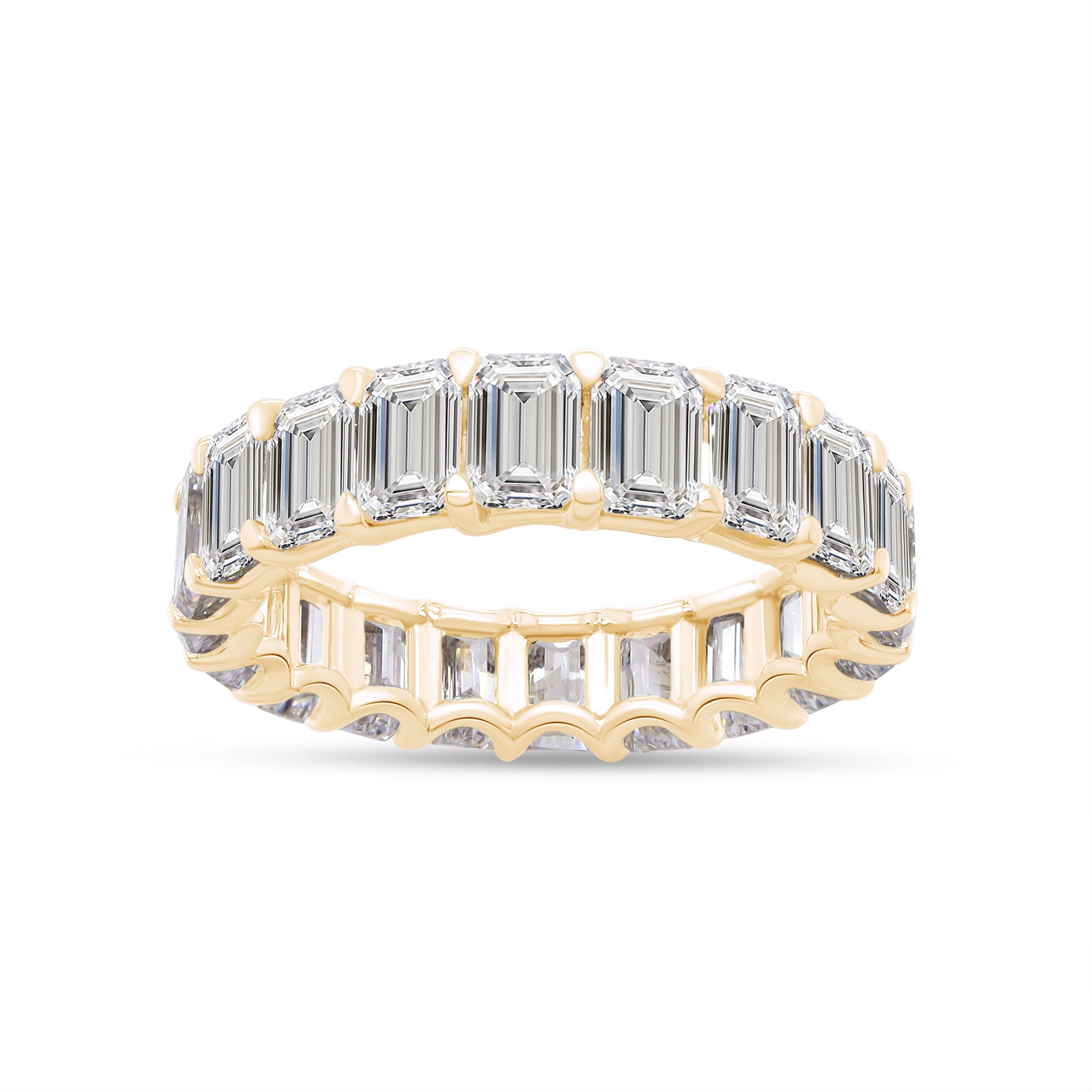 Gold ring with emerald-cut diamonds on a white background