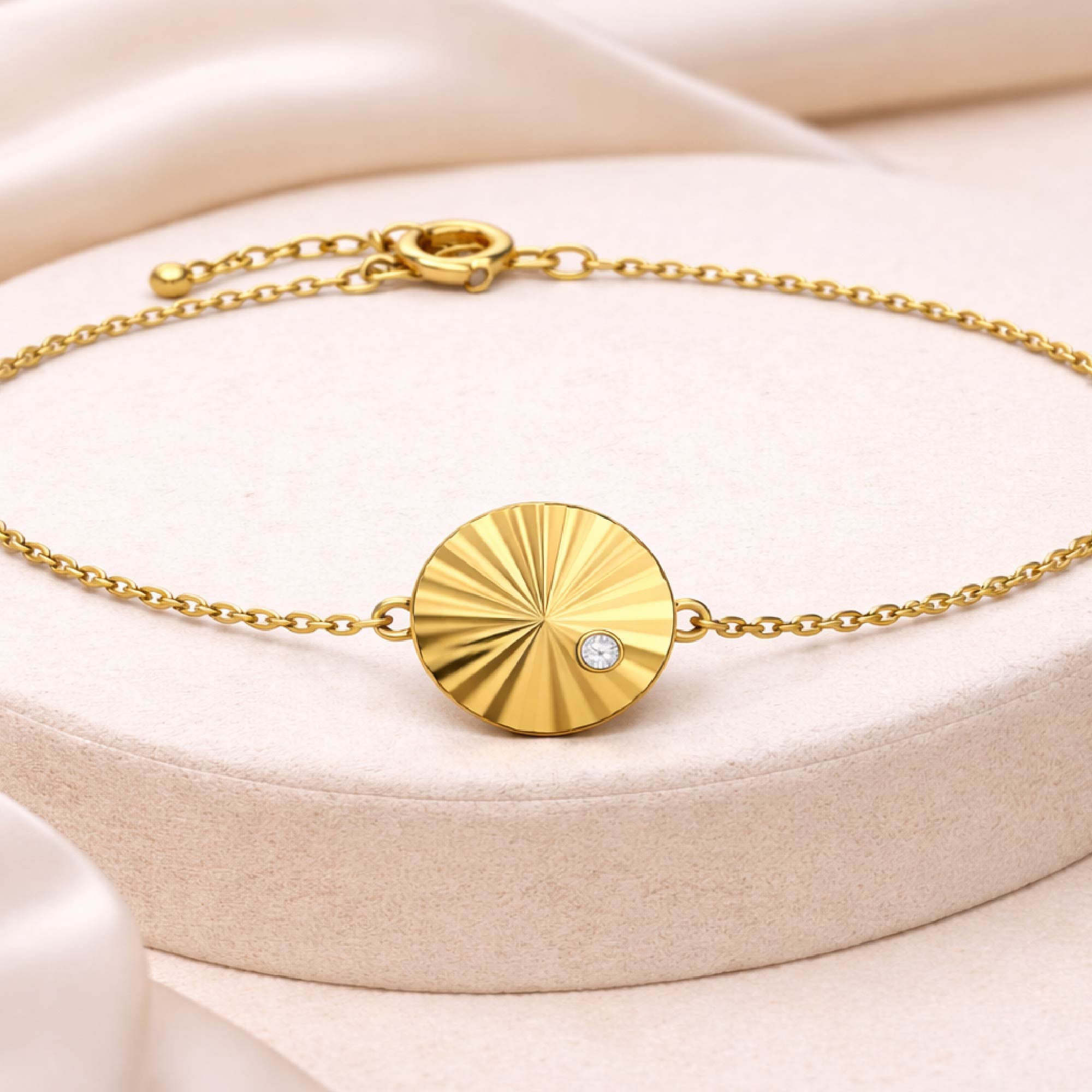 Silver bracelet with a circular pendant on a white background