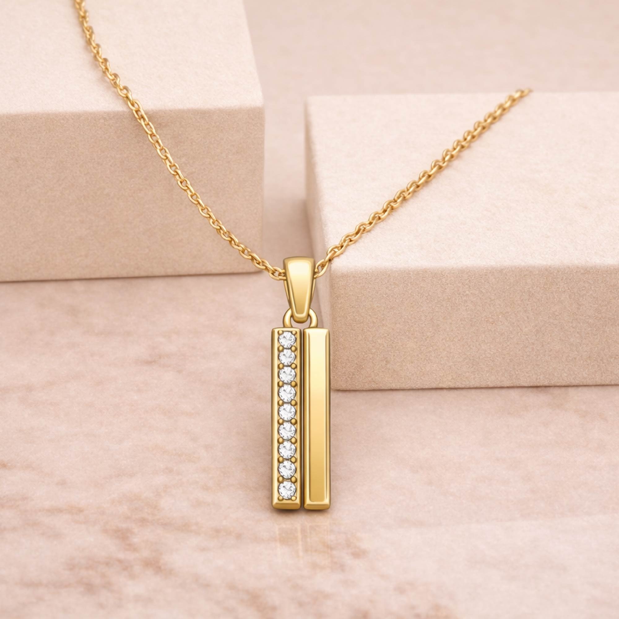 Gold necklace with a pendant on a beige background