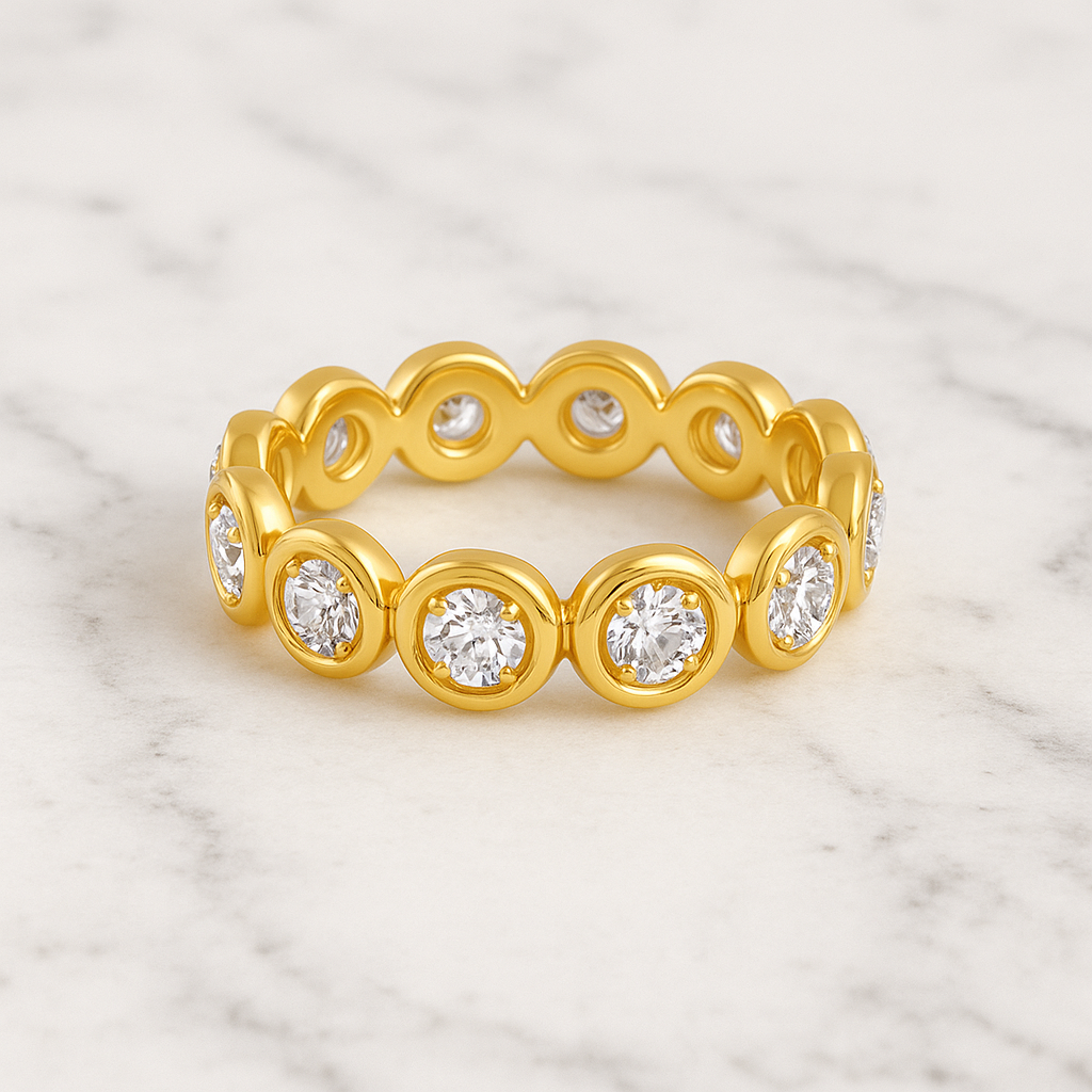 Gold ring with embedded diamonds on a marble background