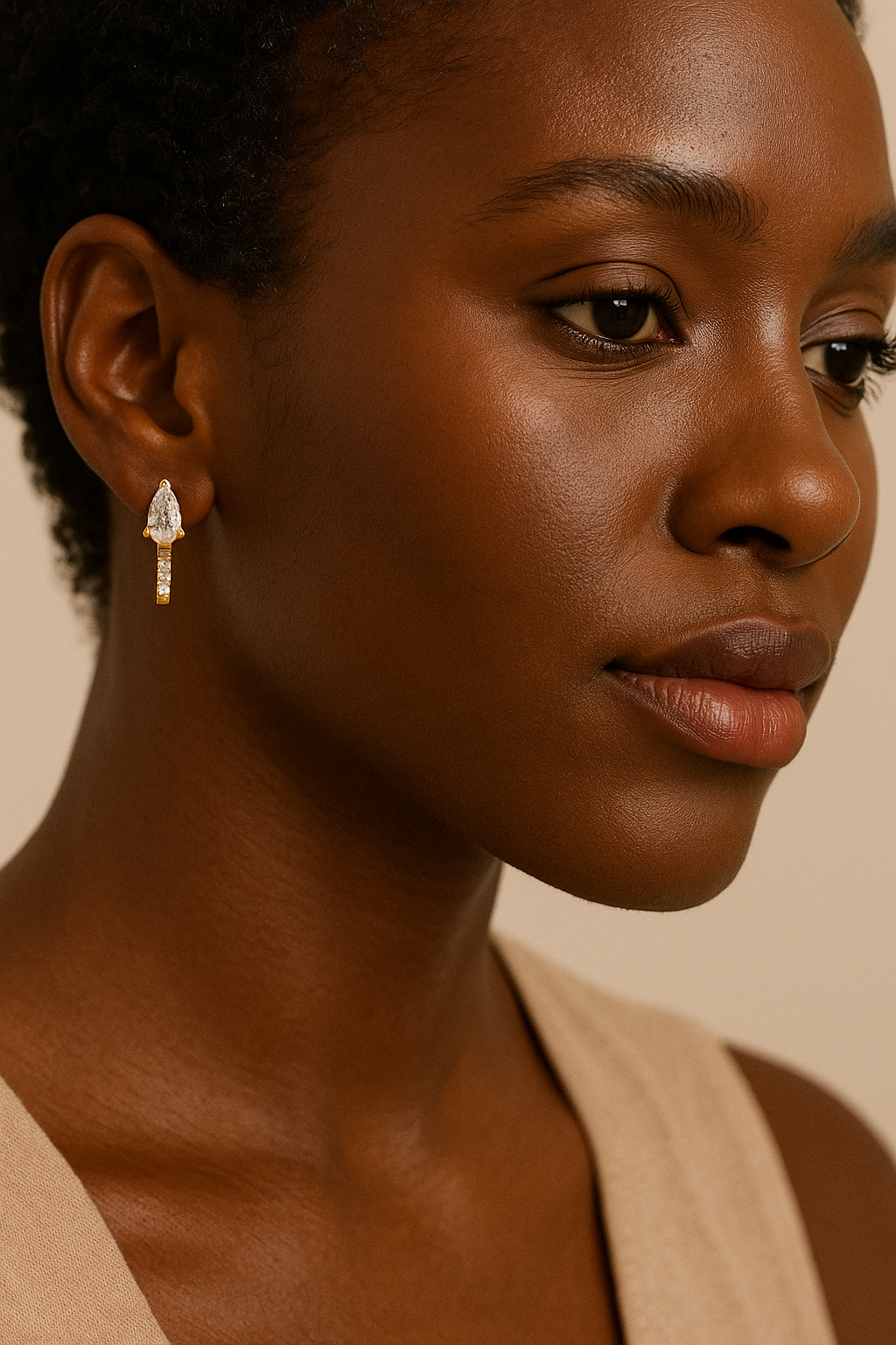 Close-up of a woman wearing elegant earrings with a neutral background