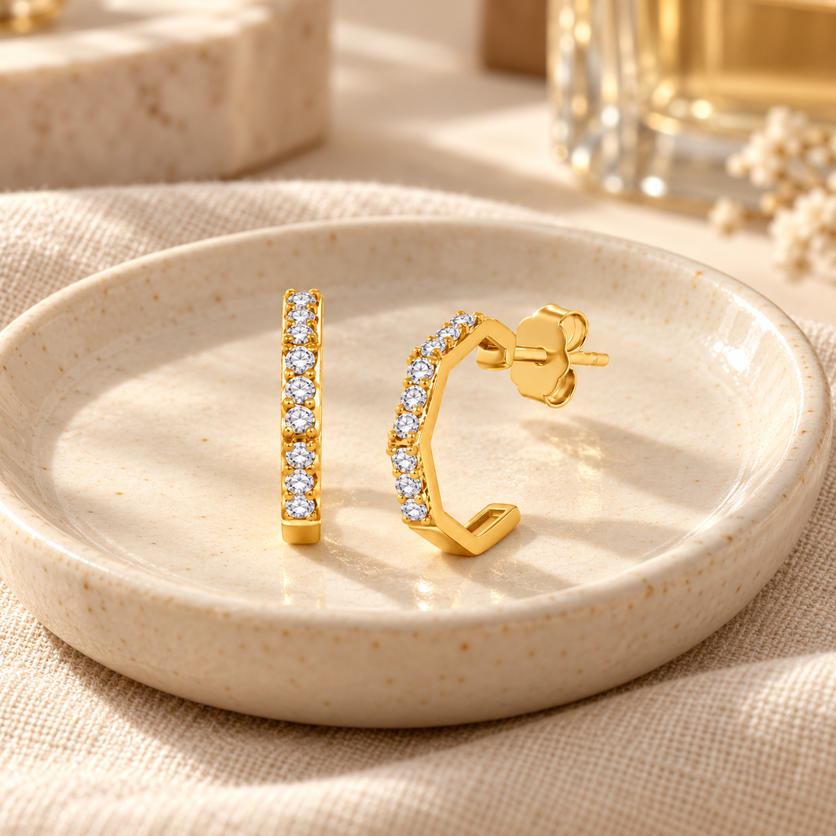 The Gold Jude Earrings with Lab Grown Diamonds on a Beige Background