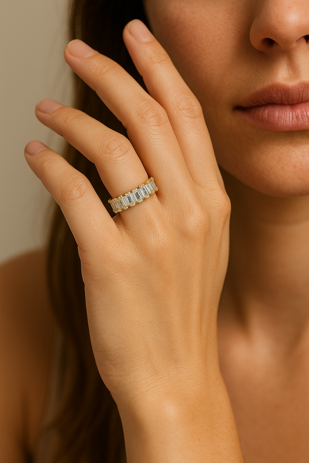 Close-up of a hand wearing a diamond ring with a neutral background