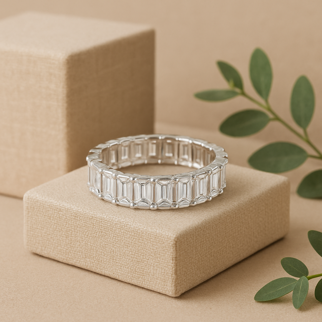Silver eternity ring on a beige box with green leaves in the background