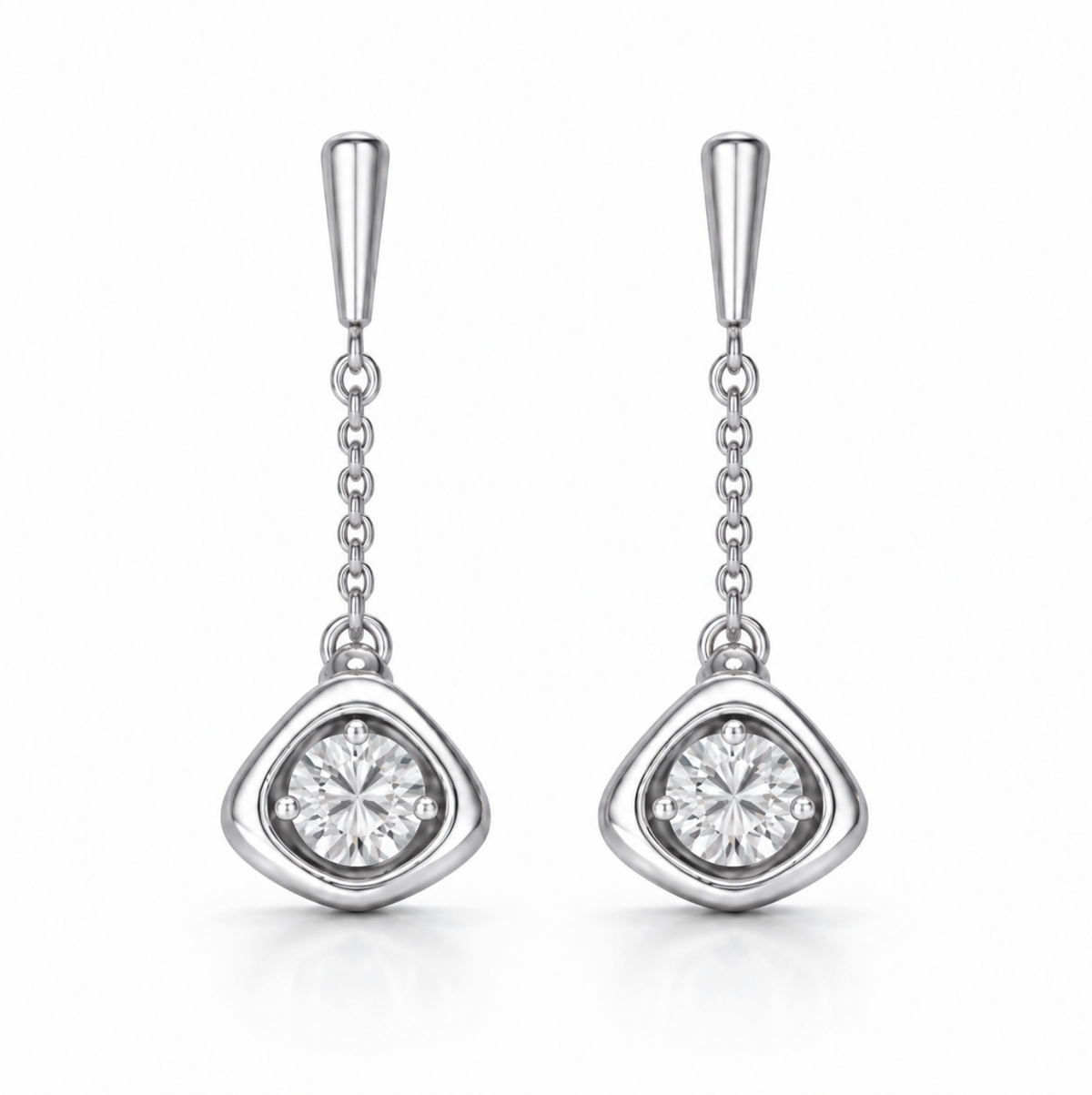 A pair of silver drop earrings with a tapered post, a short chain, and a teardrop-shaped bezel setting holding a round clear gemstone, shown on a white background.