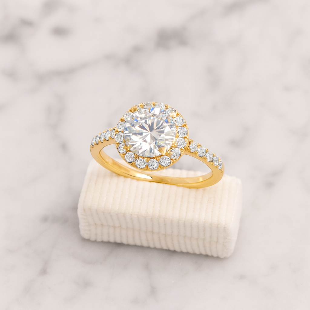 Gold ring with a large diamond on a marble surface