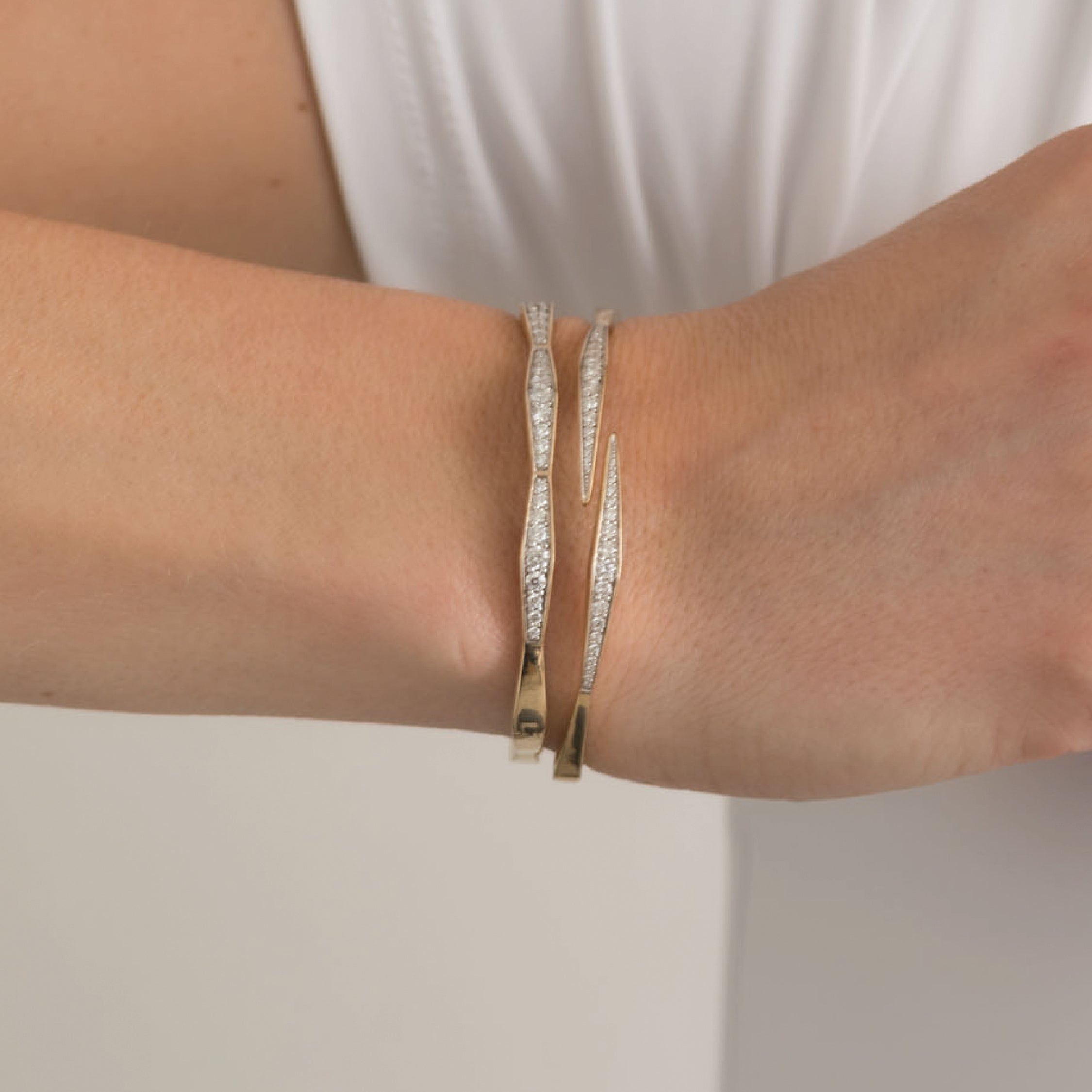 14K solid gold diamond bangle bracelet on wrist, elegant and sparkling.