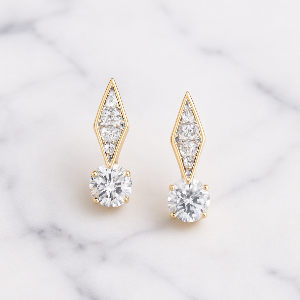Gold and crystal earrings on a marble background