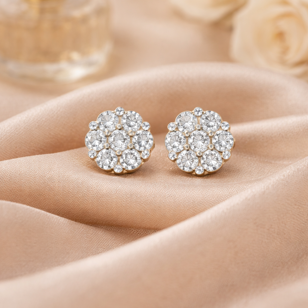 Pair of diamond earrings on a beige fabric background
