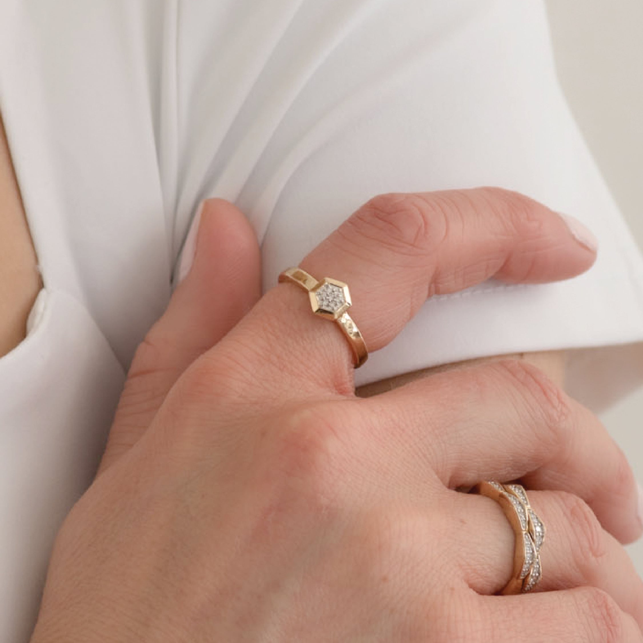 14K solid gold hexagon diamond ring on hand with polished finish