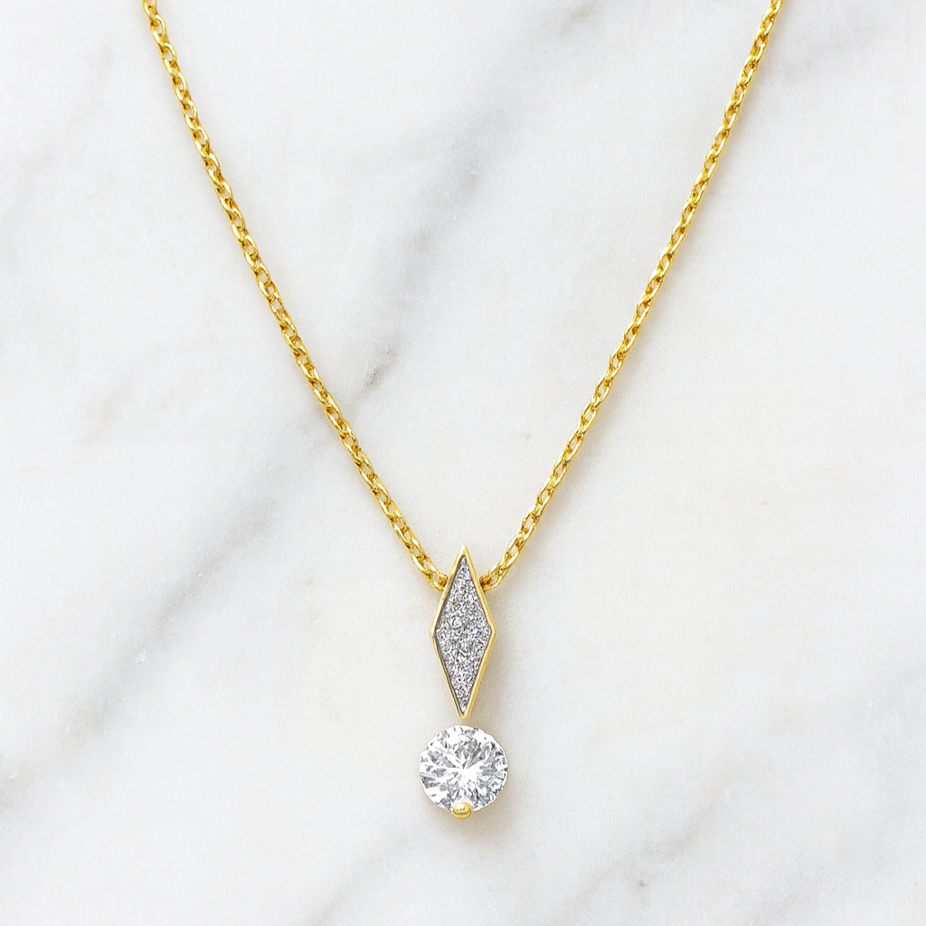 Gold necklace with a diamond pendant on a white background