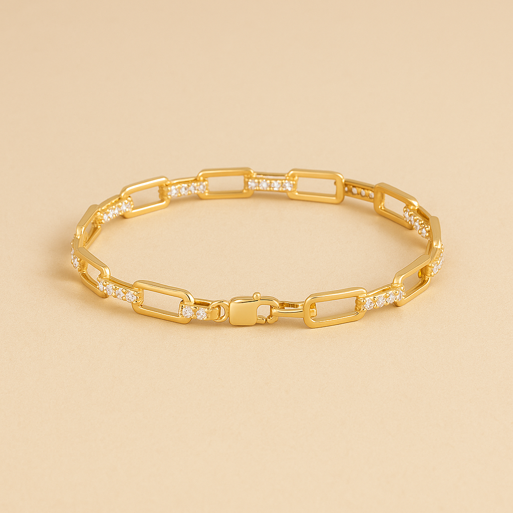 Gold bracelet with diamond accents on a beige background