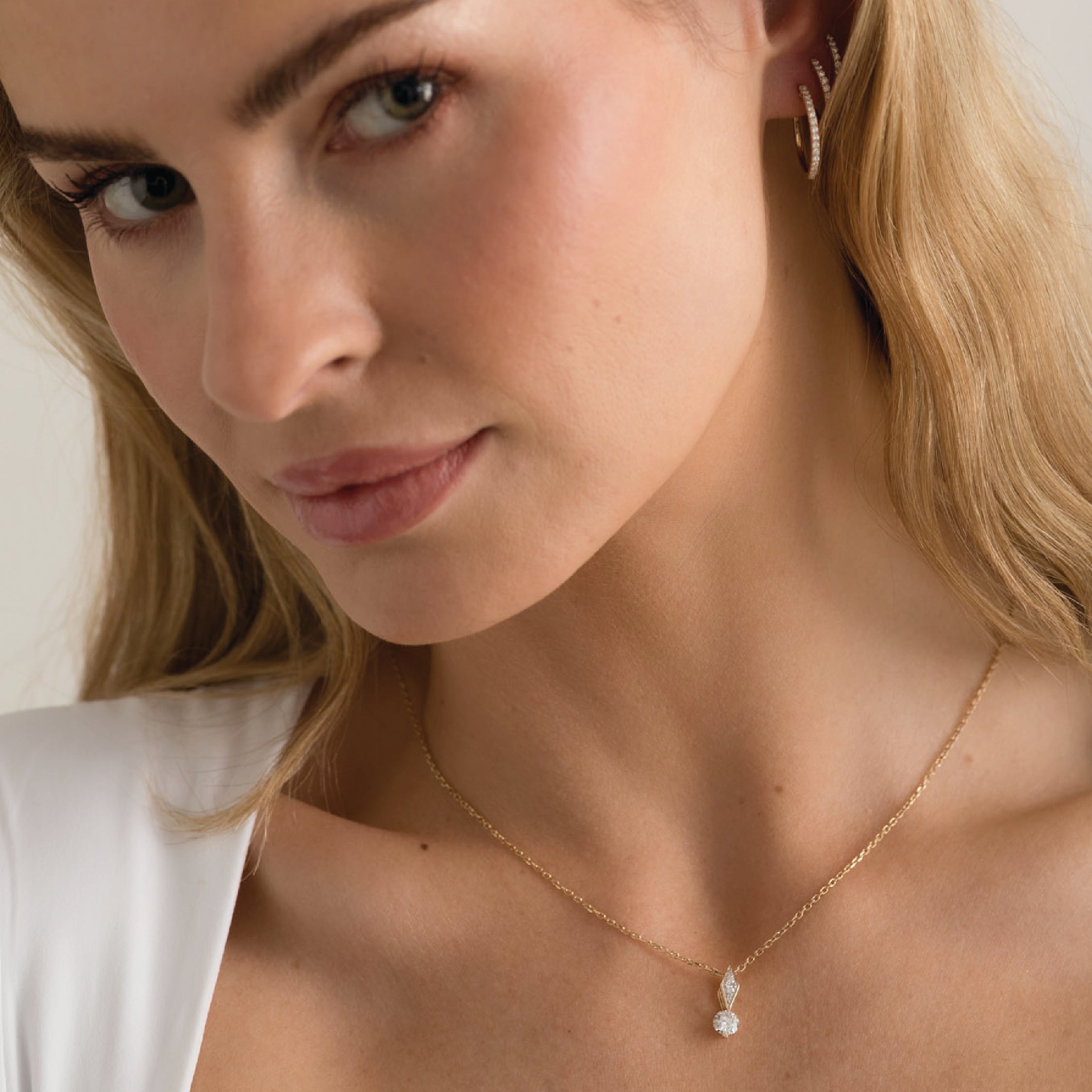 14K solid gold necklace with a white diamond pendant and cable chain.
