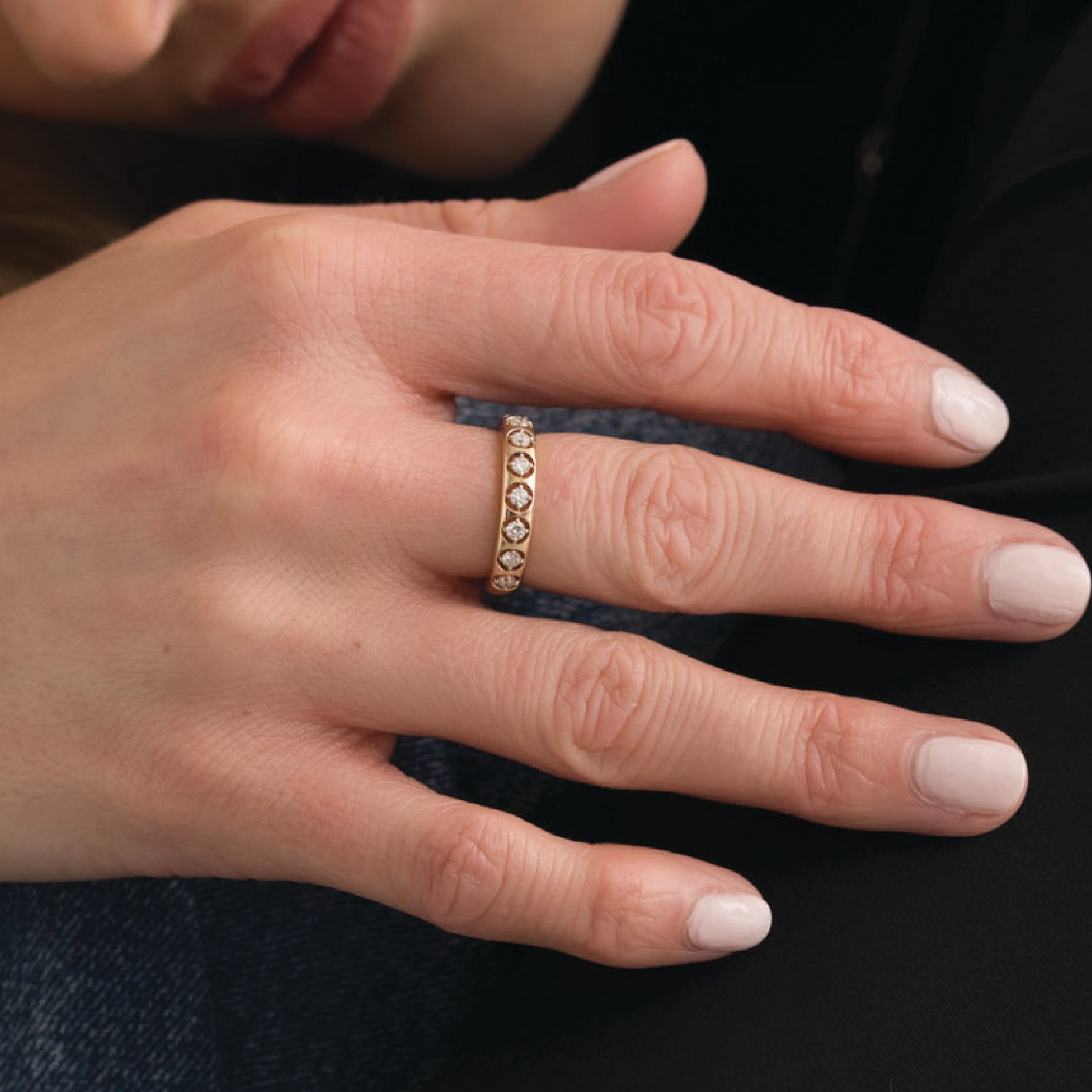 14K solid gold ring with diamonds on a hand, elegant and stackable design.