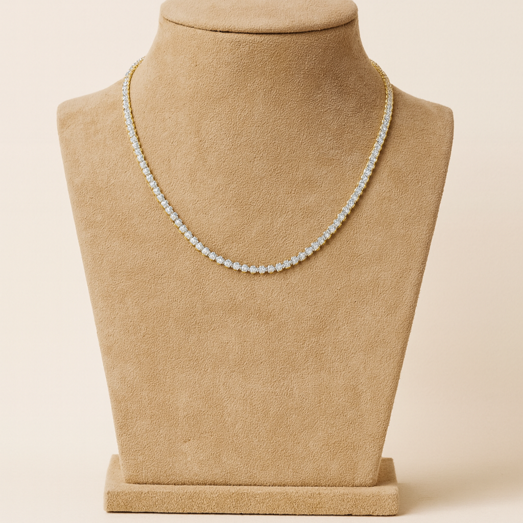 Pearl necklace on a beige mannequin bust against a beige background
