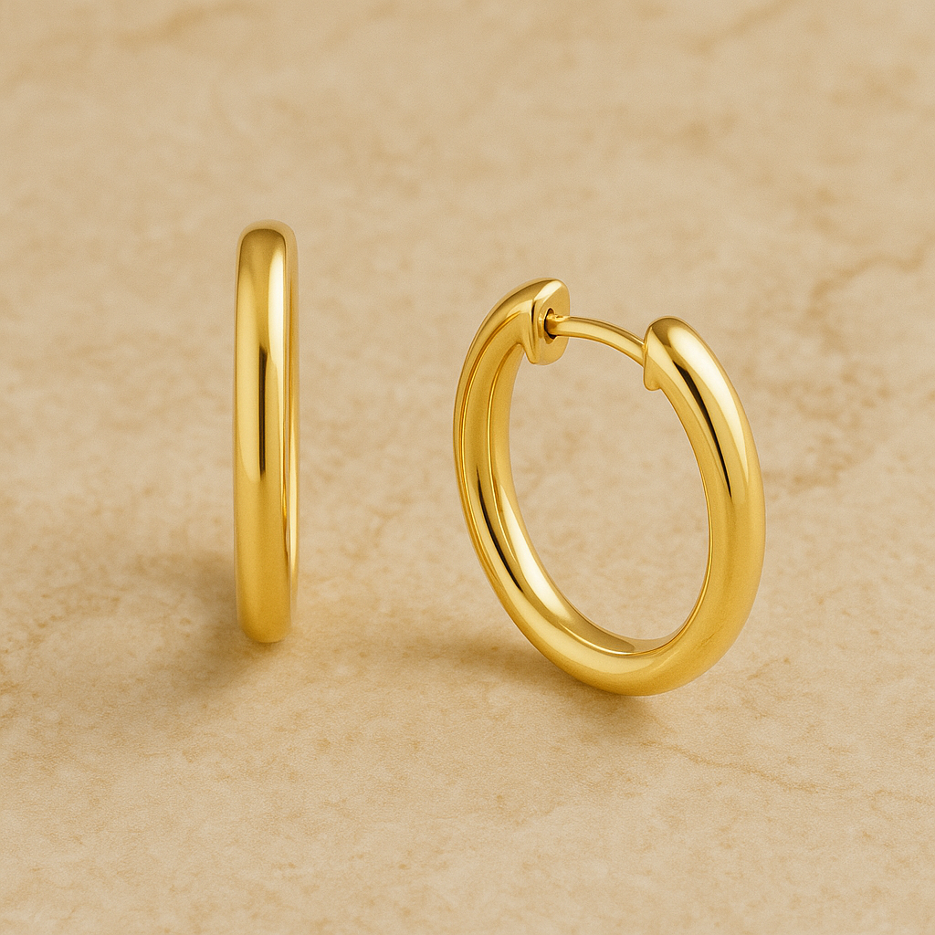 Gold hoop earrings on a beige background