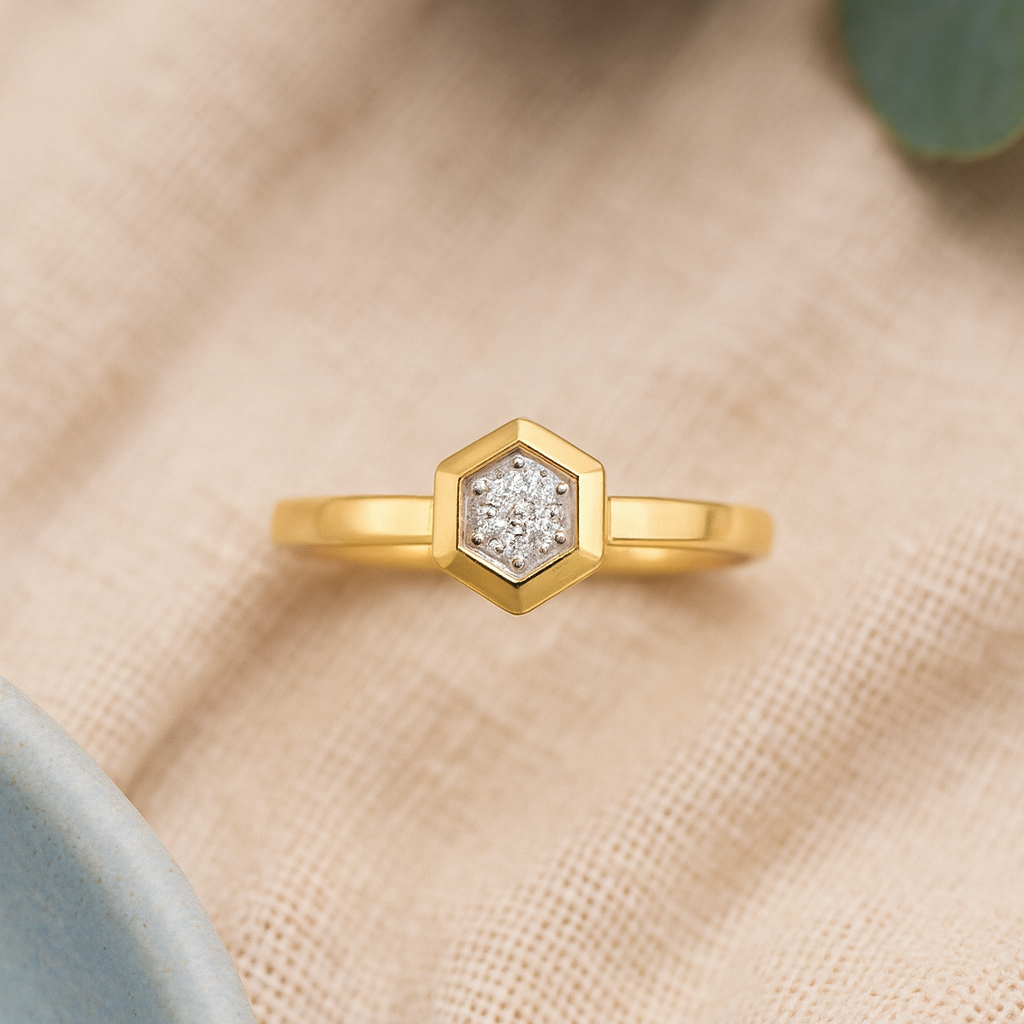Gold ring with a diamond on a beige fabric background