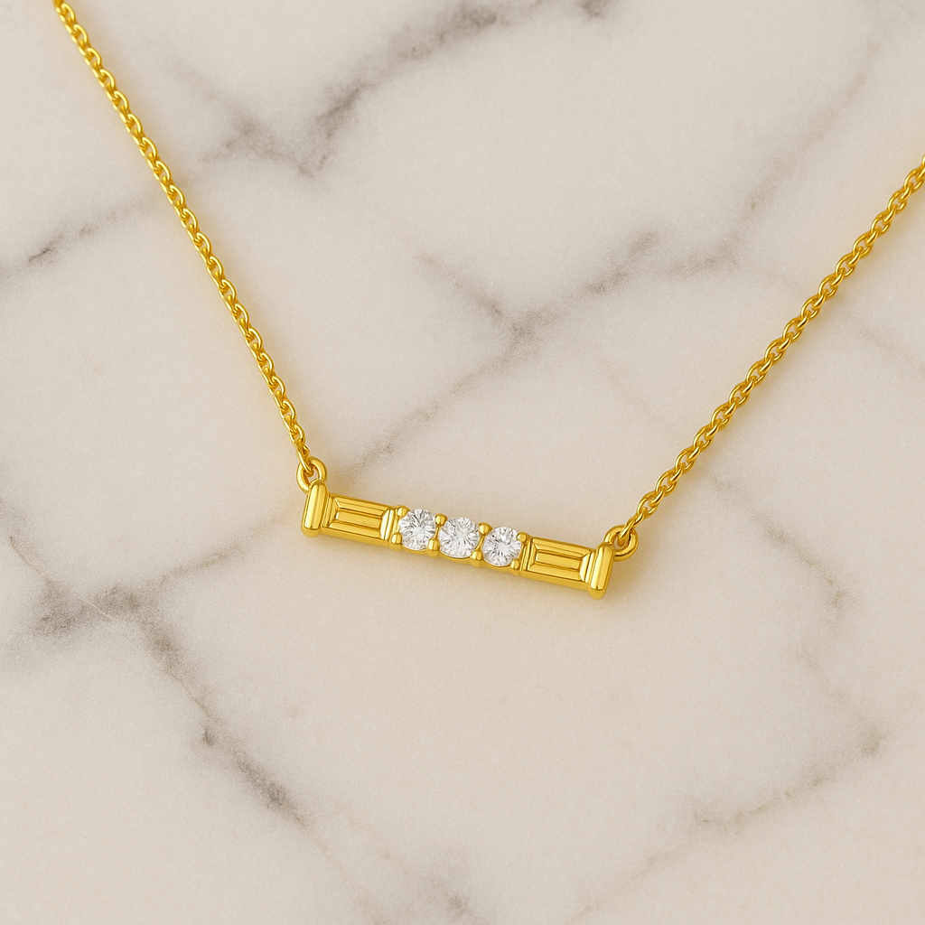 Gold necklace with three diamonds on a marble background