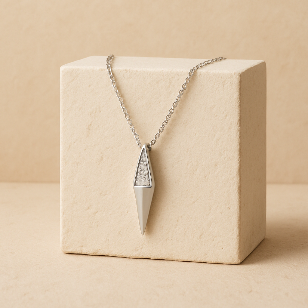 Necklace with a geometric pendant on a beige box