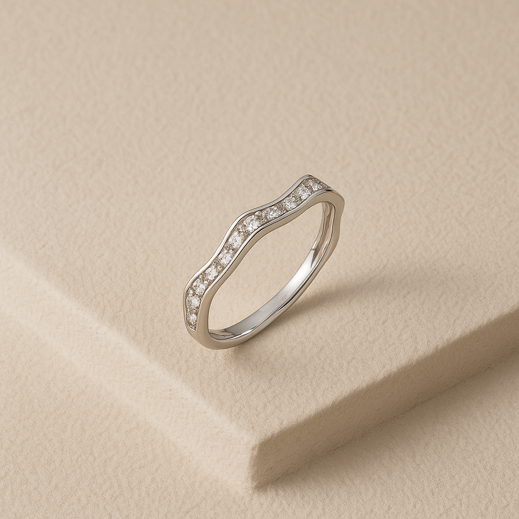 Silver ring with small diamonds on a beige background