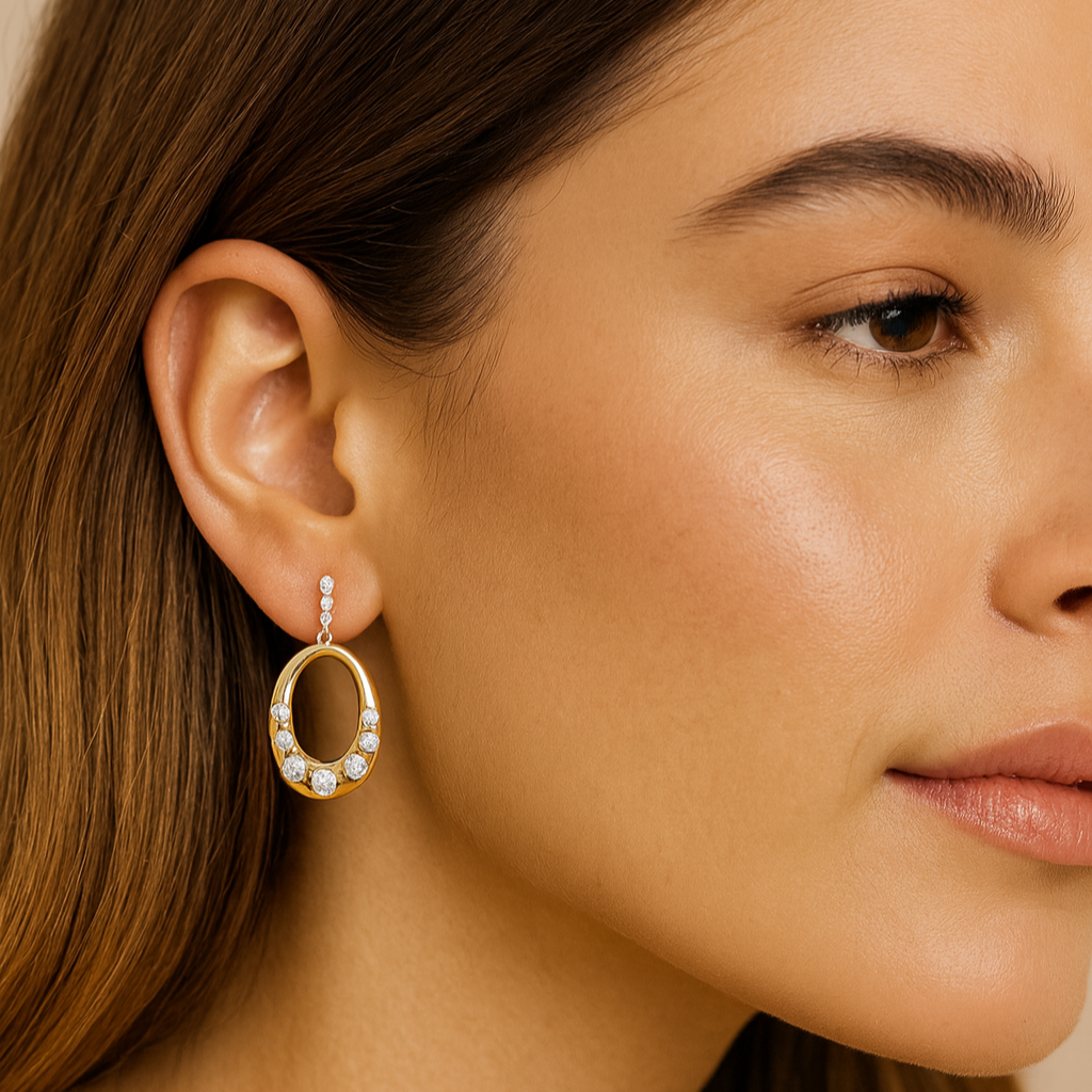Close-up of a woman wearing a gold hoop earring with small diamonds.