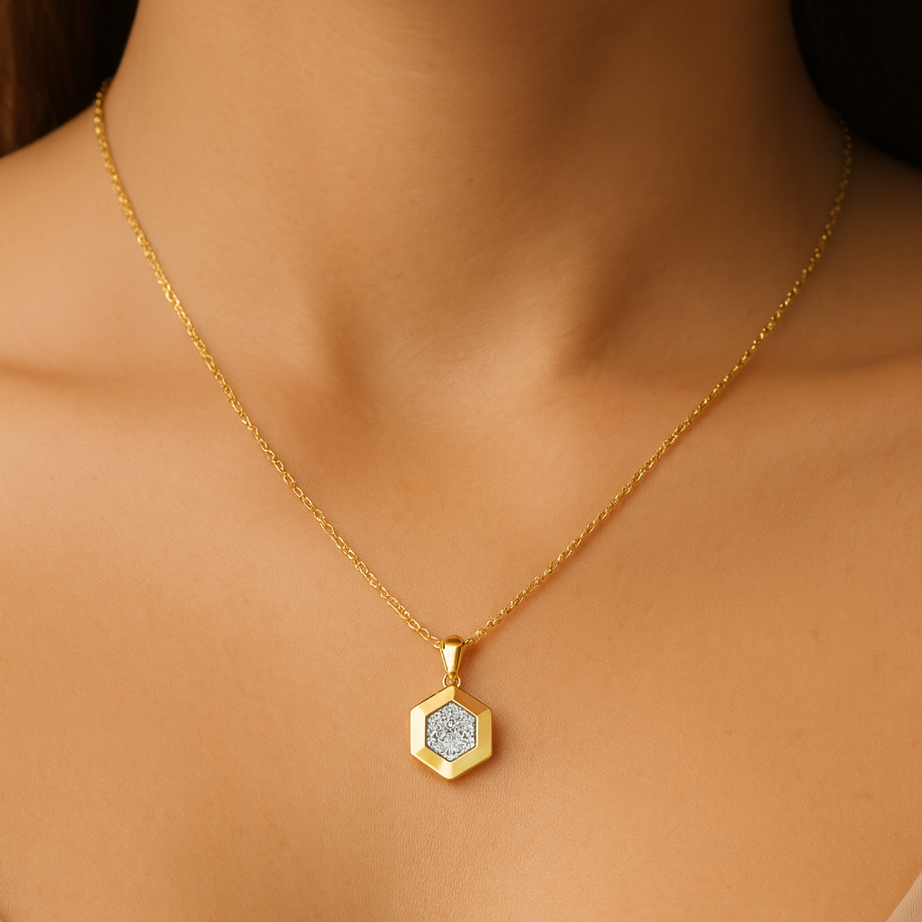 Gold necklace with a hexagonal pendant on a model against a neutral background