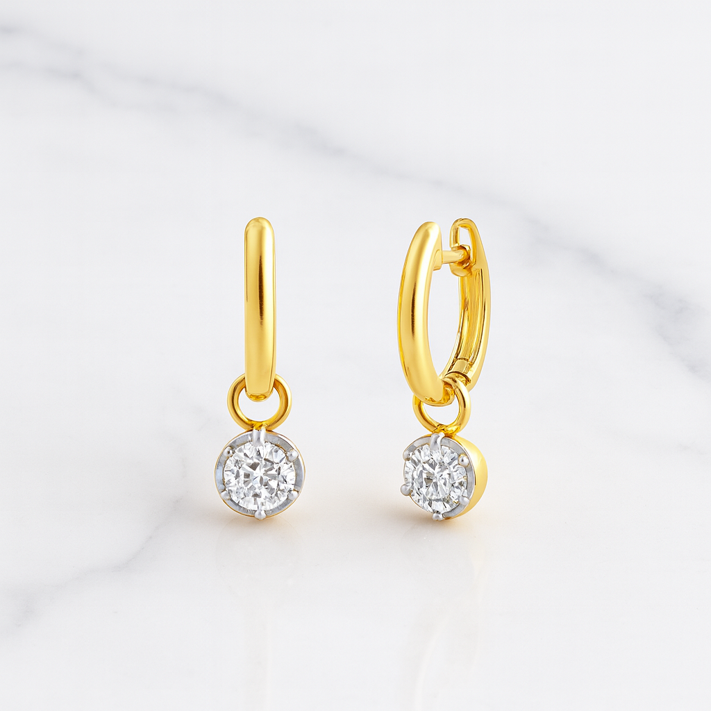 Gold hoop earrings with diamond pendants on a light gray background