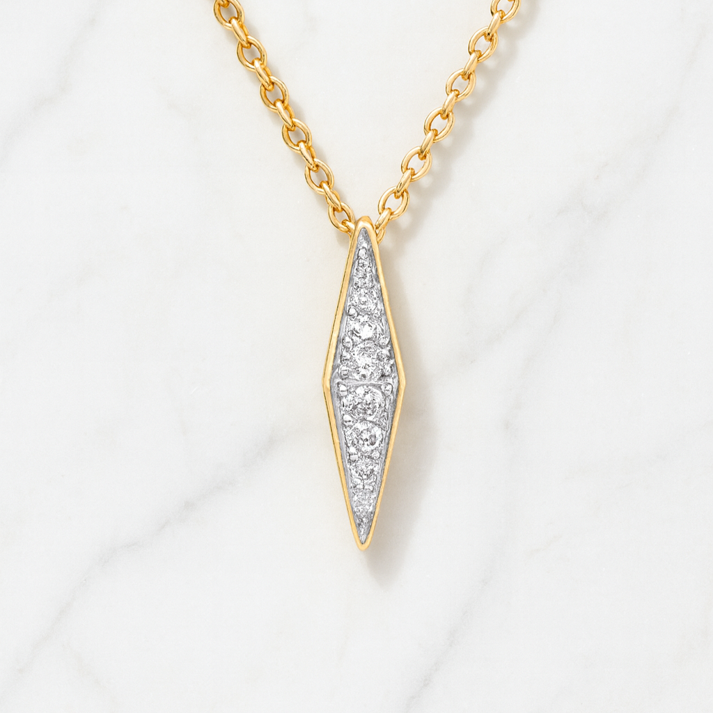Gold necklace with a diamond pendant on a white background
