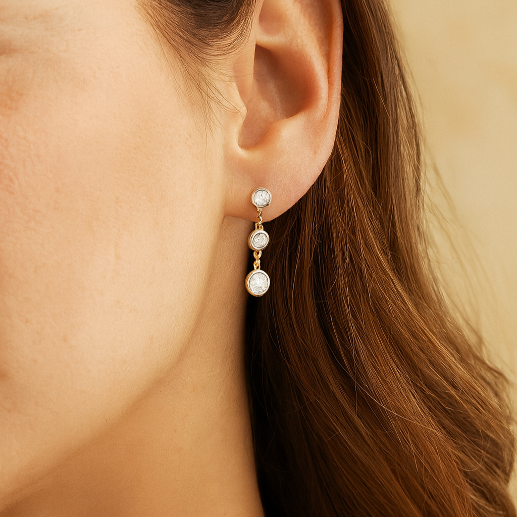 Close-up of a person wearing a pearl earring with a beige background