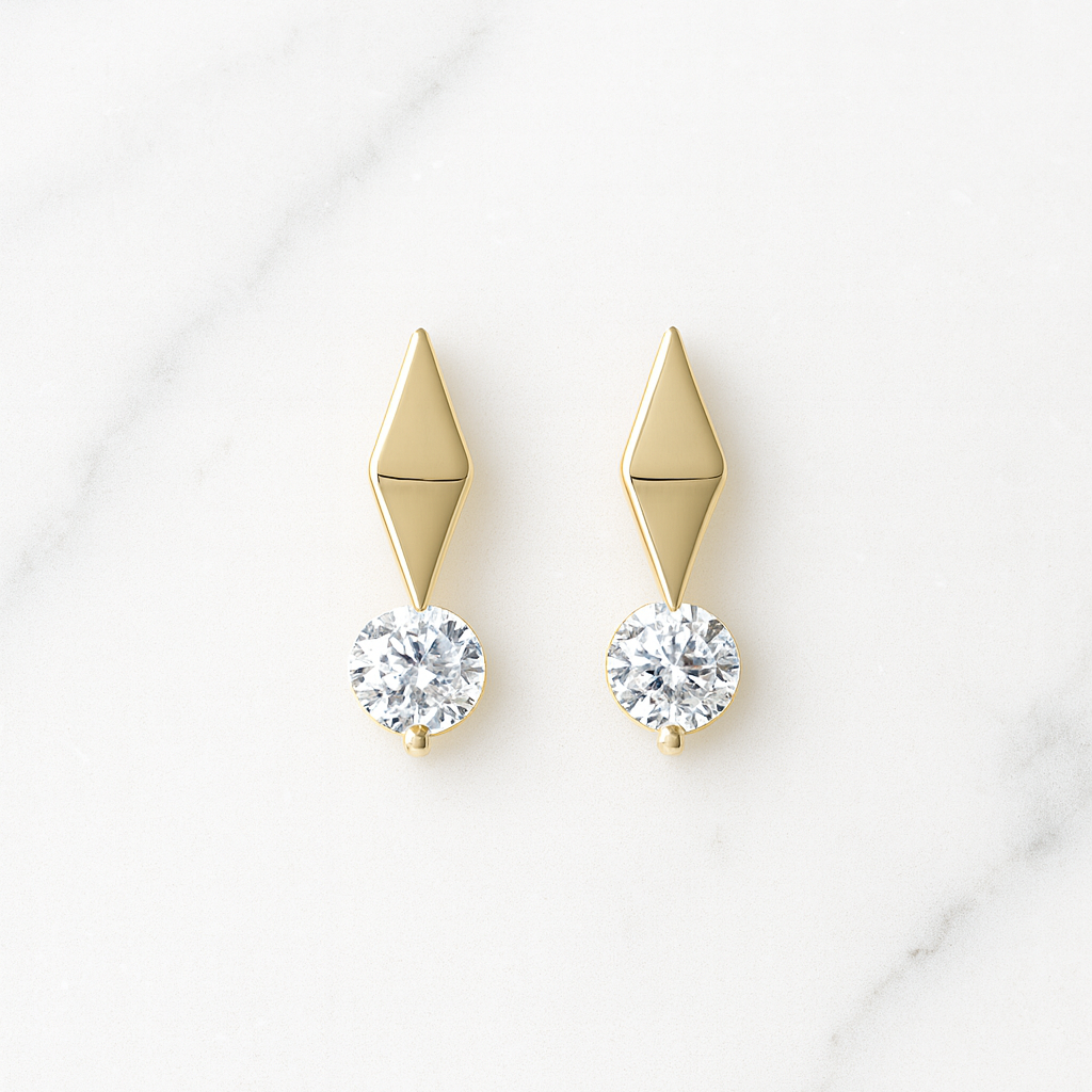 Gold earrings with diamond-like stones on a white background