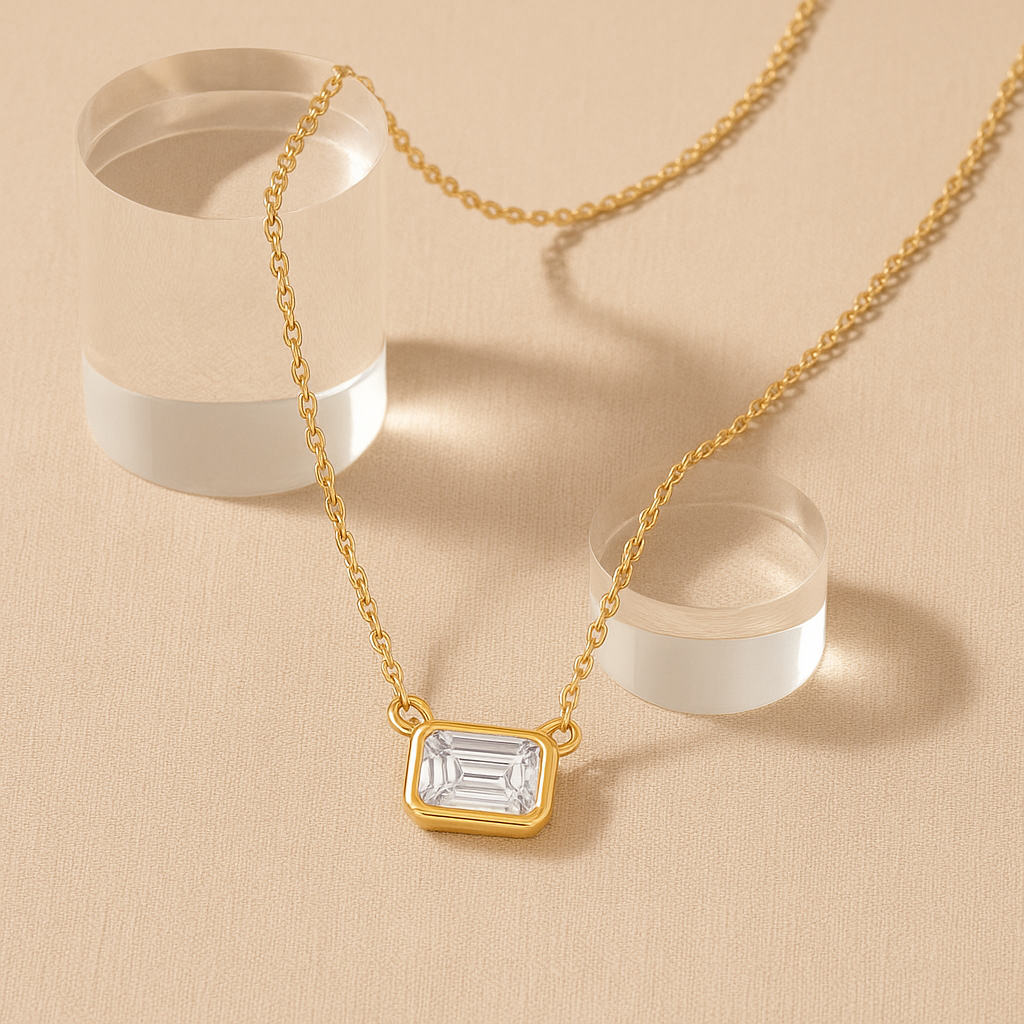 Gold necklace with a diamond pendant on a beige background