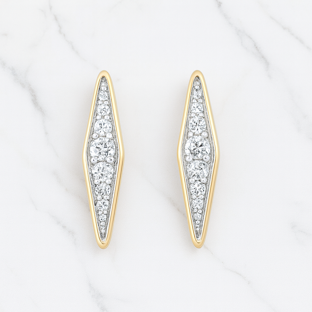 Gold and silver earrings with diamond accents on a white background