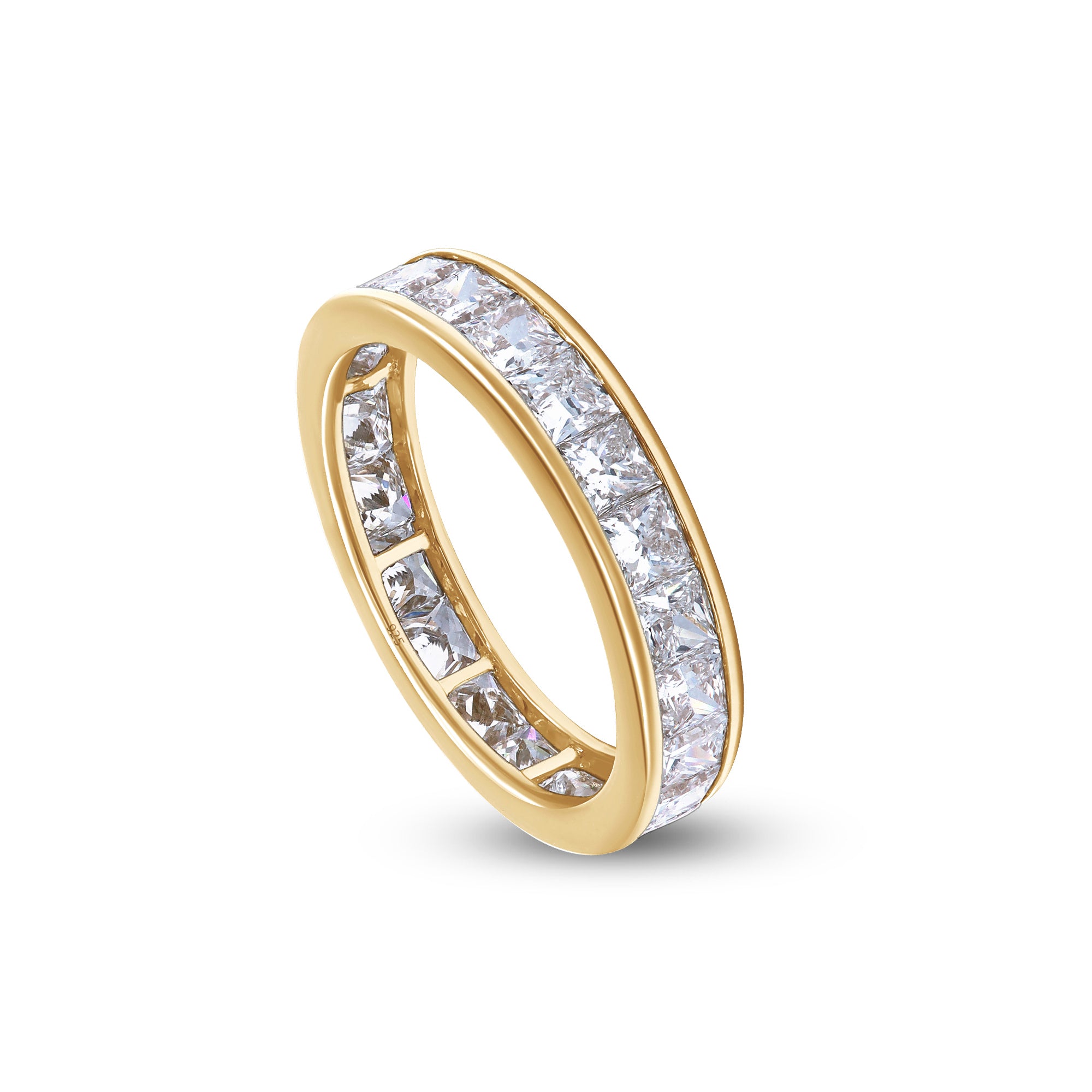Gold ring with clear gemstones on a white background