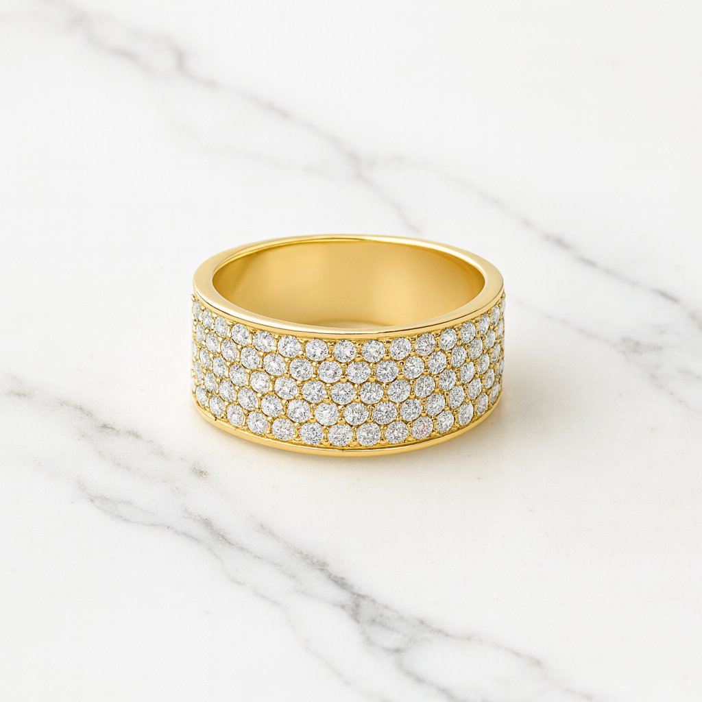 Gold ring with diamond accents on a marble surface