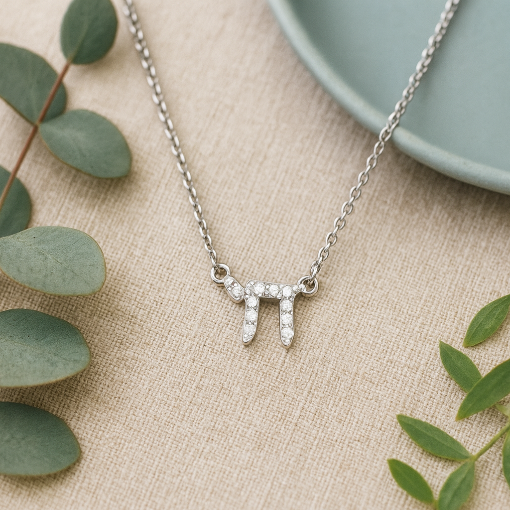 Sterling Silver Chai necklace laying on a counter
