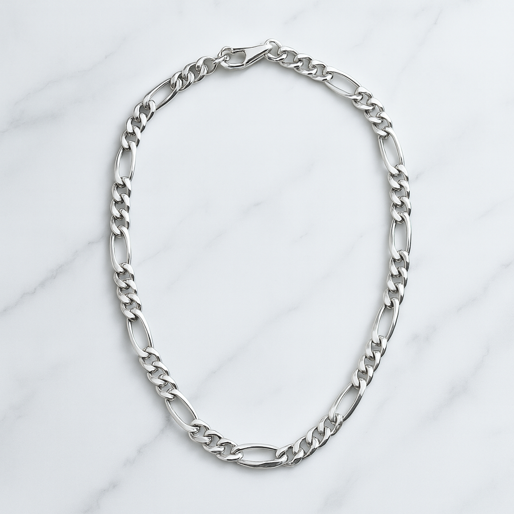Silver chain necklace on a light gray background