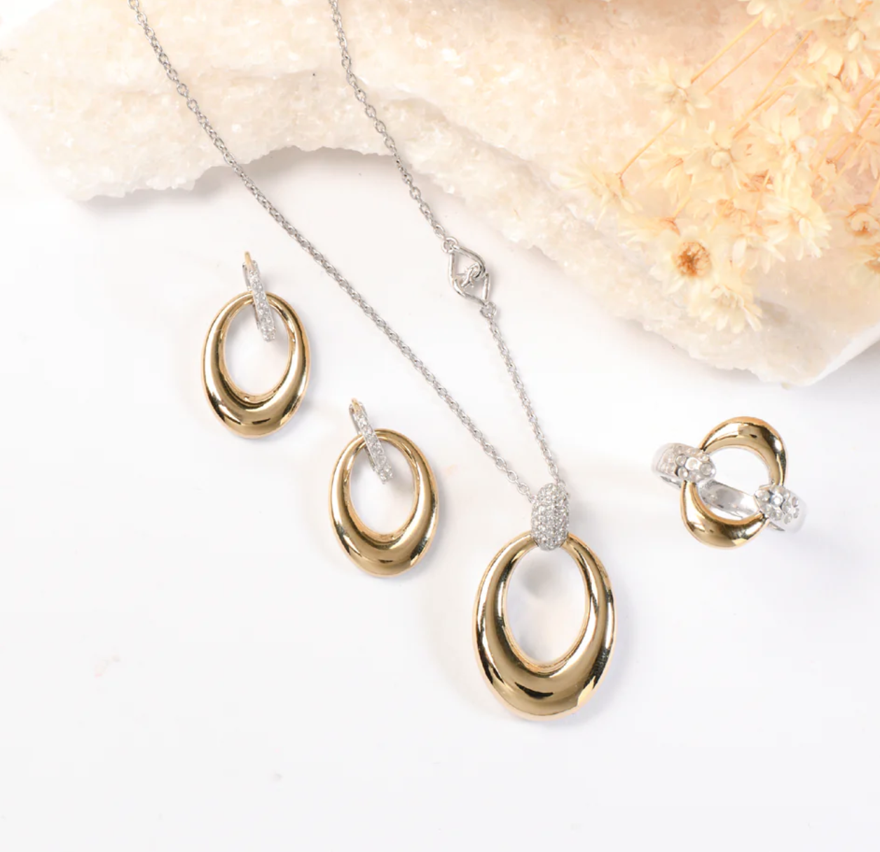 Sterling silver and 14K gold jewelry set with gemstone accents on a white background.
