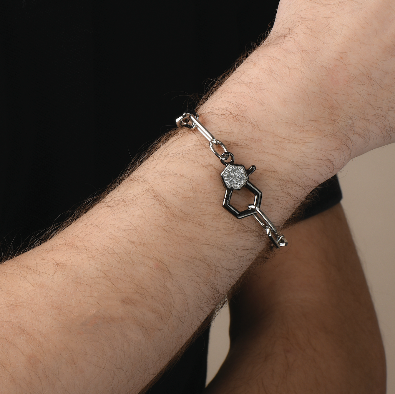Sterling silver bracelet with black accents and gemstone on wrist.