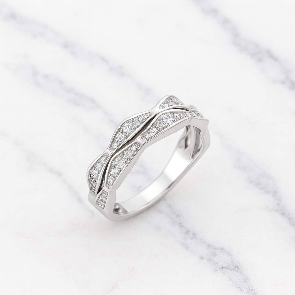 Silver ring with diamond accents on a marble background