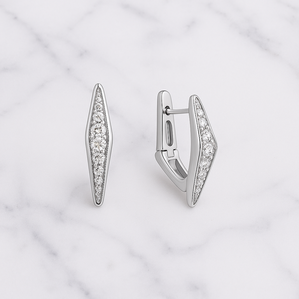 Pair of silver earrings with diamond accents on a light gray background