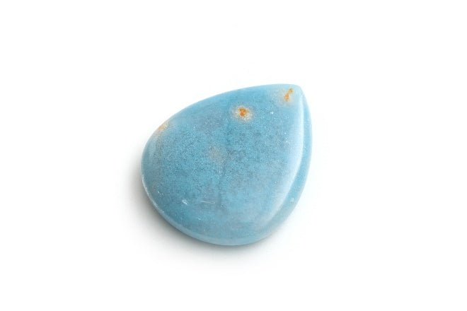 Tear-shaped blue Paraiba quartz with orange flecks on a white background.