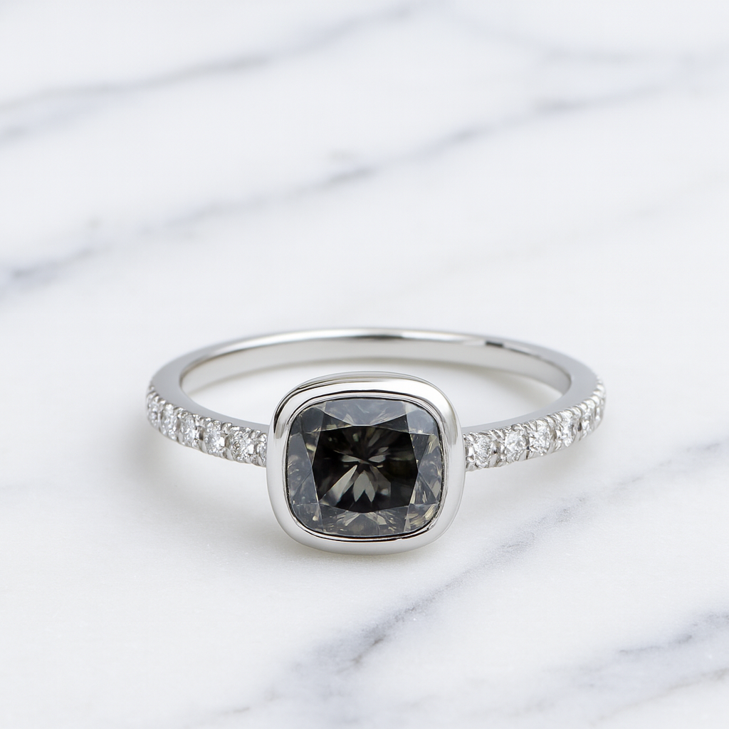 Silver ring with a black diamond on a marble background
