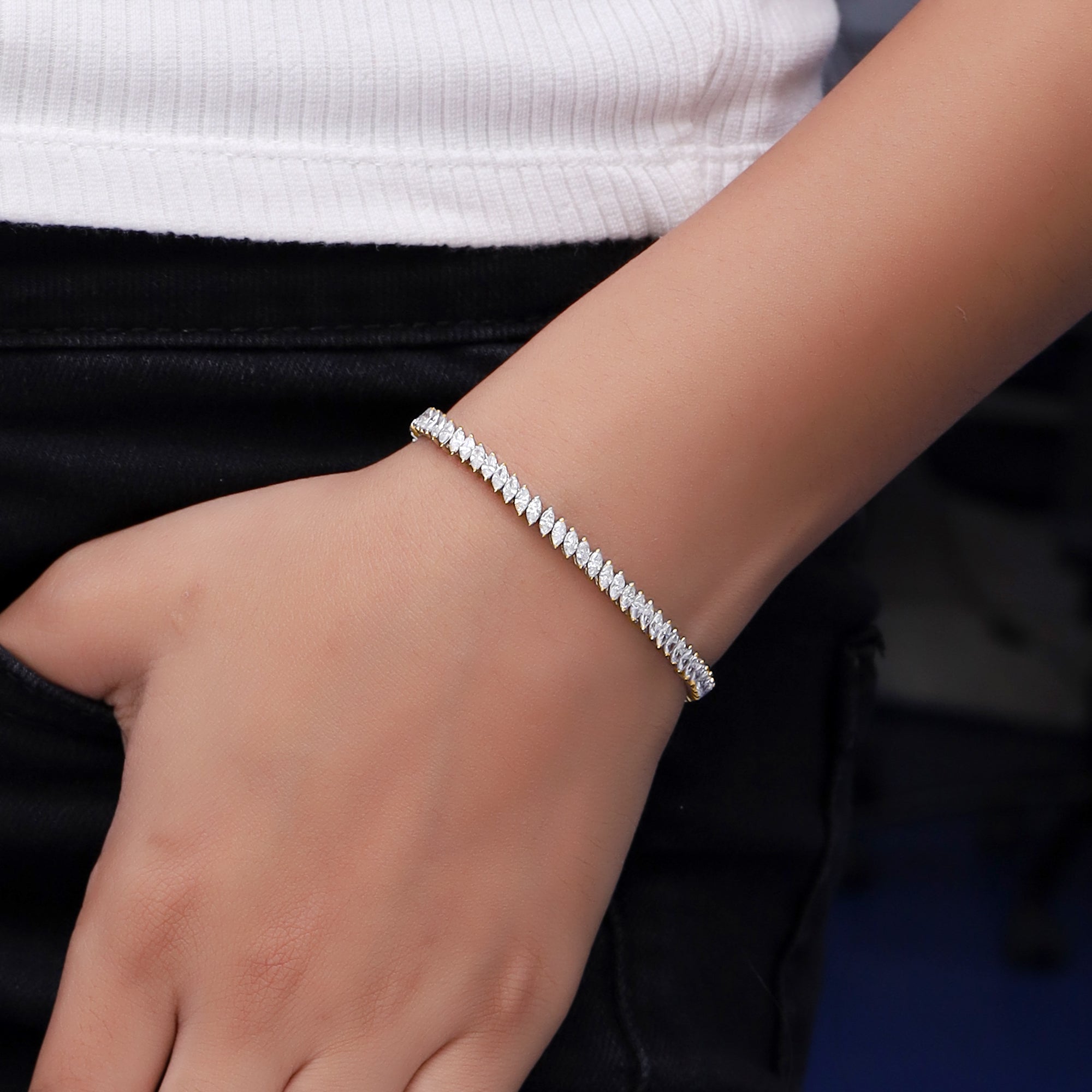 Silver bracelet on a wrist with a blurred background