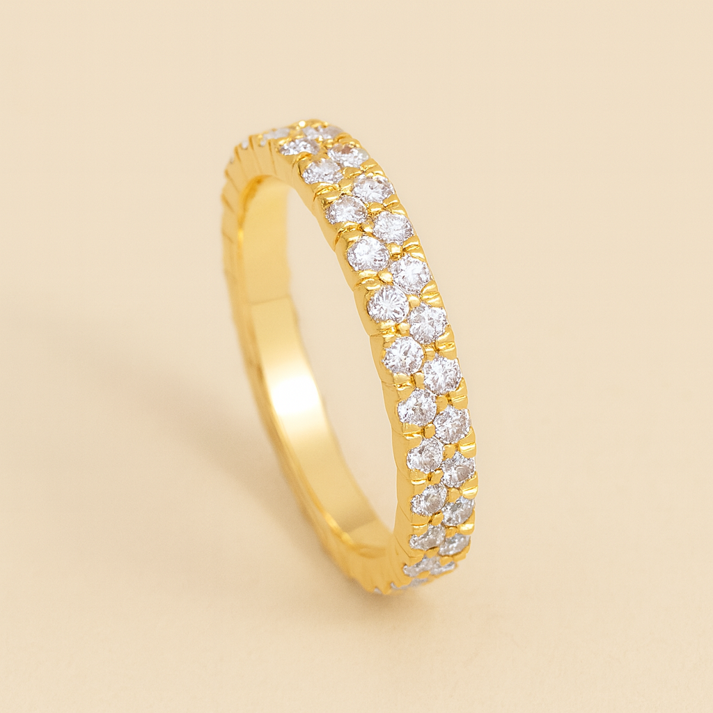 Gold ring with diamonds on a beige background