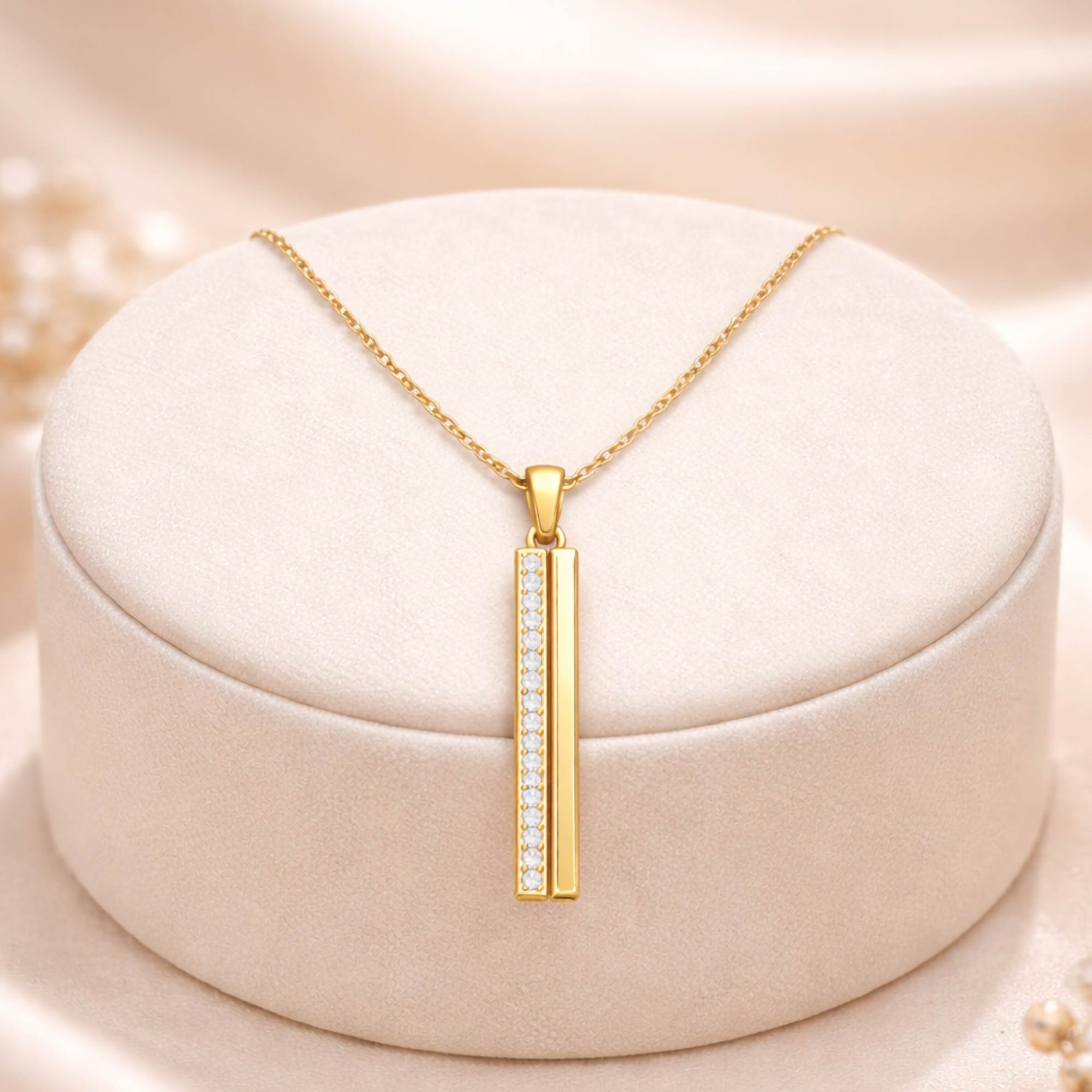 Gold necklace with a pendant on a beige cushion