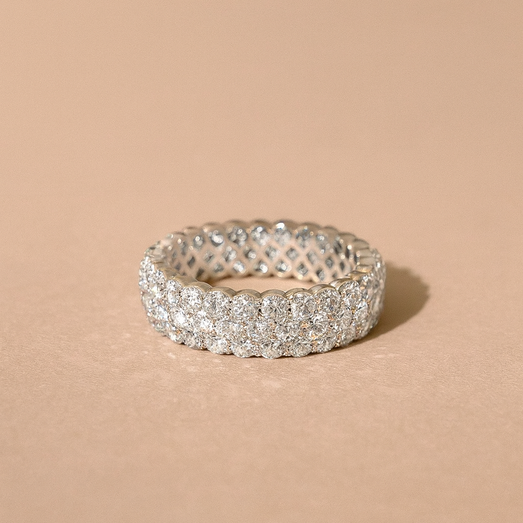 Silver ring with clear stones on a beige background