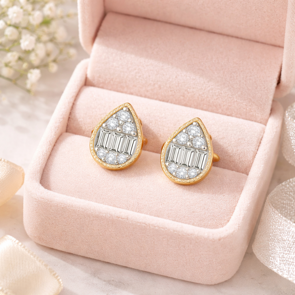Gold earrings with diamond accents on a pink jewelry box