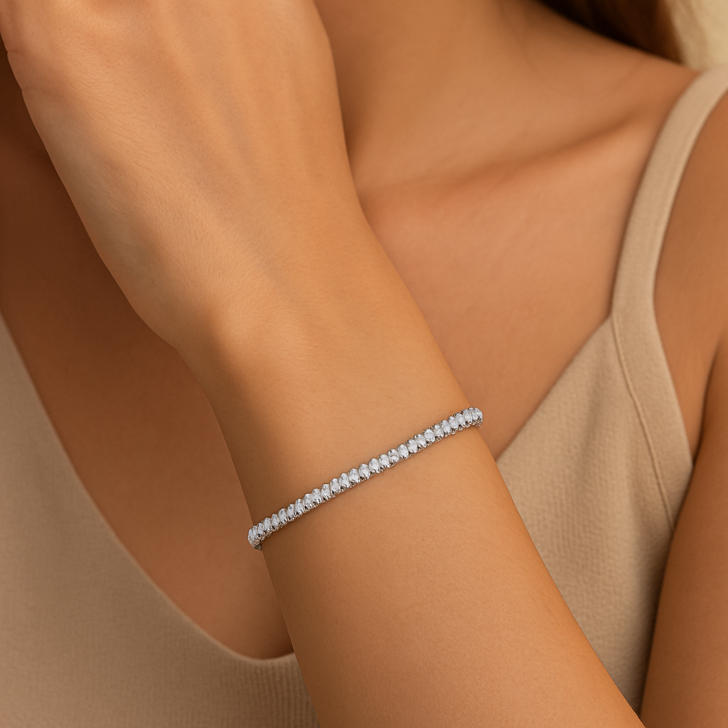 Close-up of a person wearing a silver bracelet on a beige background